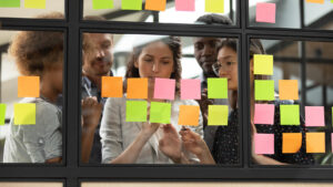 people working with sticky notes